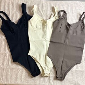 Set of Three Bodysuits in Black, Cream, and Tan